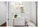 Bright bathroom with white vanity, vessel sink, modern lighting, and tiled shower at 2377 S Humboldt St, Denver, CO 80210