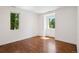Bright bedroom featuring hardwood floors, white walls, and natural light from two windows at 2377 S Humboldt St, Denver, CO 80210