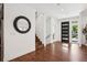 Modern entryway with hardwood floors, a decorative mirror, and stairs leading to the upper level at 2377 S Humboldt St, Denver, CO 80210