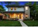Charming two-story home featuring a welcoming porch and beautifully landscaped front yard at 2377 S Humboldt St, Denver, CO 80210