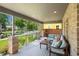 Inviting front porch with ample seating area and brick support posts at 2377 S Humboldt St, Denver, CO 80210