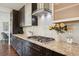 Modern kitchen features stainless steel appliances, granite countertops, gas range, and dark wood cabinetry at 2377 S Humboldt St, Denver, CO 80210