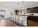 Modern kitchen with a large island, pendant lighting, and stainless steel appliances at 2377 S Humboldt St, Denver, CO 80210