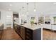 Spacious kitchen with large center island, stainless steel appliances, and open floor plan to the living room at 2377 S Humboldt St, Denver, CO 80210