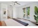 Large main bedroom featuring a ceiling fan, neutral decor, and access to a private balcony at 2377 S Humboldt St, Denver, CO 80210