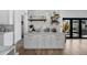 Stylish bar area with white cabinets, stone countertop and decorative shelves at 4176 Zenobia St, Denver, CO 80212