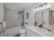 Bright bathroom with subway tile shower, black hardware, and a modern vanity at 4176 Zenobia St, Denver, CO 80212