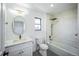 A bathroom with modern fixtures, bright lighting, and a combined bathtub/shower at 4176 Zenobia St, Denver, CO 80212