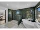 Modern bathroom with a glass shower, soaking tub, and elegant tile work at 4176 Zenobia St, Denver, CO 80212