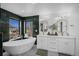 Elegant bathroom features a soaking tub, double vanity, and stylish fixtures at 4176 Zenobia St, Denver, CO 80212