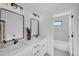 Modern bathroom with double sinks, elegant mirrors, and a connecting bath area at 4176 Zenobia St, Denver, CO 80212