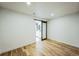 A spacious bedroom with hardwood floors and a modern sliding door entrance at 4176 Zenobia St, Denver, CO 80212