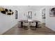 This dining room features modern light fixture, large windows, and hardwood floors at 4176 Zenobia St, Denver, CO 80212