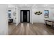 Open floor plan with hardwood floors, black double door entrance, and stylish wall accents at 4176 Zenobia St, Denver, CO 80212