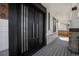 Modern covered entry porch with stacked stone accents and a contemporary glass panel double door at 4176 Zenobia St, Denver, CO 80212
