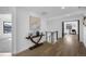 Bright hallway featuring stylish decor, hardwood floors, and staircase access at 4176 Zenobia St, Denver, CO 80212
