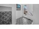Hallway view highlighting patterned tile flooring and a doorway to an outdoor space at 4176 Zenobia St, Denver, CO 80212
