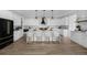 Gourmet kitchen with a large center island, modern pendant lights, and white cabinetry at 4176 Zenobia St, Denver, CO 80212