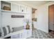 Mudroom with built-in storage and a decorative welcome sign at 4176 Zenobia St, Denver, CO 80212