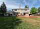 Backyard with a wooden deck, a small storage shed, and plenty of grass at 16835 E Harvard Pl, Aurora, CO 80013
