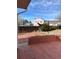 View of a two-story home with a wood deck and brick patio and sparse lawn area in the backyard at 16835 E Harvard Pl, Aurora, CO 80013