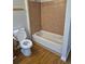 Cozy bathroom featuring a white bathtub and brown tiled shower at 16835 E Harvard Pl, Aurora, CO 80013