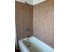 Bathroom featuring a bathtub with a tile surround and modern fixtures at 16835 E Harvard Pl, Aurora, CO 80013