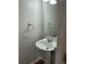 Cozy half bathroom featuring a pedestal sink, classic mirror and neutral paint at 16835 E Harvard Pl, Aurora, CO 80013