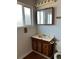 Bathroom featuring a single sink vanity with storage and a mirror at 16835 E Harvard Pl, Aurora, CO 80013