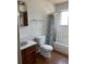 Bathroom features a toilet, tub with shower, and a single sink vanity with wood-look flooring at 16835 E Harvard Pl, Aurora, CO 80013