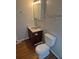Bathroom features a single sink vanity, decorative mirror and toilet at 16835 E Harvard Pl, Aurora, CO 80013