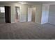 A spacious bedroom featuring a carpeted floor and a closet with mirrored doors at 16835 E Harvard Pl, Aurora, CO 80013
