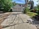 Two-story home featuring a two-car garage, red shutters, a driveway, and mature trees at 16835 E Harvard Pl, Aurora, CO 80013