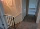 Upstairs hallway featuring carpet flooring, leading to bedrooms and bathroom at 16835 E Harvard Pl, Aurora, CO 80013