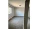 The carpeted living room features neutral walls, modern baseboards and trim, and a bright window at 16835 E Harvard Pl, Aurora, CO 80013