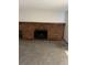 Living room with large brick fireplace, gray carpet and neutral paint at 16835 E Harvard Pl, Aurora, CO 80013