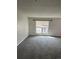 Bright living room featuring gray carpet and a large window with views at 16835 E Harvard Pl, Aurora, CO 80013