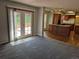 Open-concept living room with carpet, a door to a deck, and an island kitchen at 16835 E Harvard Pl, Aurora, CO 80013