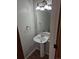 Powder room with pedestal sink, mirror, lighting and a towel ring at 16835 E Harvard Pl, Aurora, CO 80013
