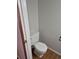 Powder room with standard toilet, laminate floor, and neutral paint at 16835 E Harvard Pl, Aurora, CO 80013