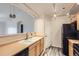 Efficient kitchen area with ample cabinets, track lighting, and a view to the connected living area at 5255 Memphis St # 224, Denver, CO 80239