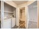 Convenient laundry area with washer, dryer, and access to adjacent bedroom and bathroom at 5255 Memphis St # 224, Denver, CO 80239