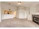 Spacious living room showcasing an open layout with neutral colors, plush carpet, and a cozy fireplace at 5255 Memphis St # 224, Denver, CO 80239