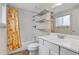 Bathroom with a shower-tub, white vanity, and bright floral shower curtain at 7148 S Dahlia Ct, Centennial, CO 80122