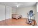 Spacious bedroom with hardwood floors, a ceiling fan, and ample natural light at 7148 S Dahlia Ct, Centennial, CO 80122