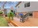 Outdoor deck featuring wicker furniture, an outdoor rug, and backyard views at 7148 S Dahlia Ct, Centennial, CO 80122