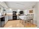 Bright eat-in kitchen featuring grey cabinets, stainless steel appliances, and wooden flooring at 7148 S Dahlia Ct, Centennial, CO 80122