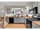 Charming kitchen with grey cabinets, granite countertops, and a view of the backyard at 7148 S Dahlia Ct, Centennial, CO 80122