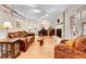 Spacious living room with hardwood floors, fireplace, comfortable seating, and access to an office area at 7148 S Dahlia Ct, Centennial, CO 80122