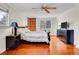 Large bedroom with hardwood floors, built-in shelving, and a comfortable bed at 7148 S Dahlia Ct, Centennial, CO 80122